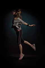 Fototapeta na wymiar young woman dancing in studio