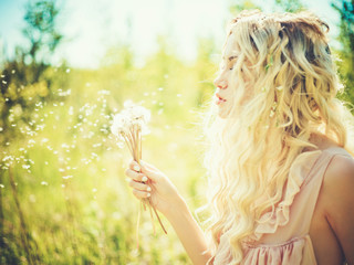 Beautiful blonde with dandelions