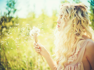 Beautiful blonde with dandelions - Powered by Adobe