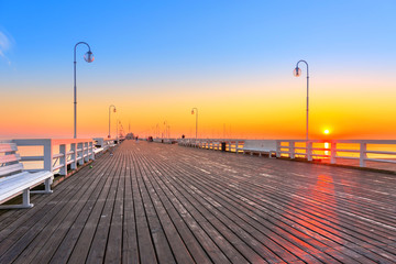 Fototapeta na wymiar Sunrise at wooden pier (molo) in Sopot, Poland