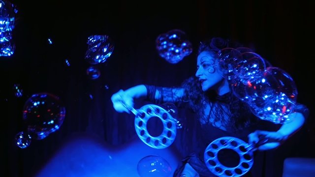 female performer in soap bubbles magician show