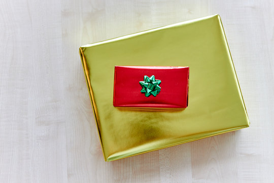 Top view showing red and golden gifts on wooden background
