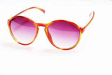 Pink sunglasses on white background