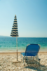 Sunbeds with umbrellas on a beautiful beach with clear water