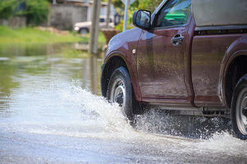 Splash by a car as it goes through flood water