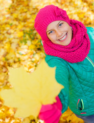 Cute girl with autumn leaves