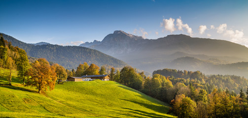 Beautiful autumn landscape with farm house in the Alps