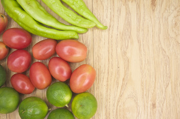 Fresh green goat pepper tomato and lemon on side
