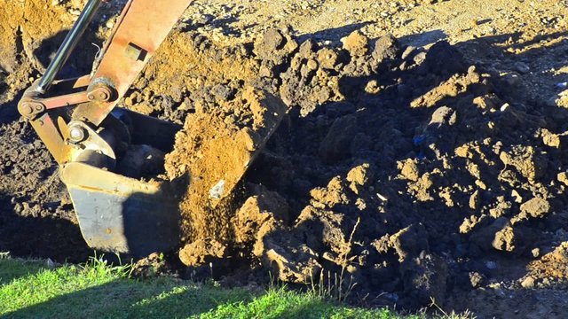 Excavator is digging the ground