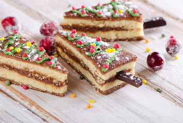 Christmas sweet  tree made of  cake on  a wooden background .