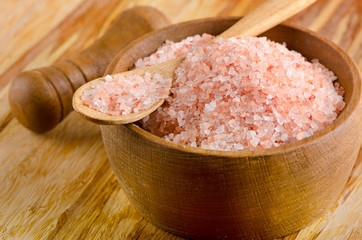 himalayan pink salt in  wooden bowl.