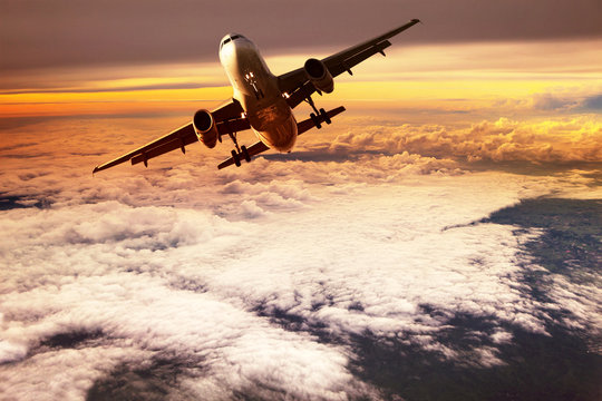 Passenger Jet Plane Take Off To Mid Air Against Beautiful Golden