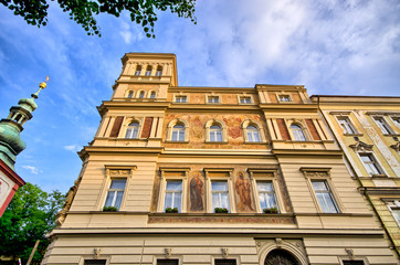 Fototapeta na wymiar Old tenement house with dramatic sky in Prague - Czech Republic