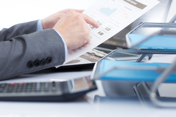 Businessman analyzing investment charts with laptop. Accounting