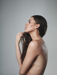 Nude female model on grey background