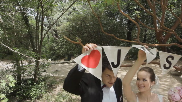 Stylish bride and groom enjoy each other in the park