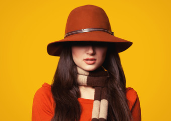 Style brunette girl on yellow background.