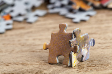Two Jigsaw Puzzle Pieces on Table