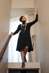 Stylish older woman in black evening dress