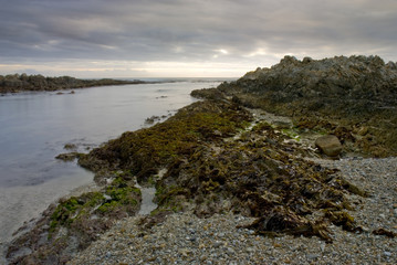 Sunset over rocky beach and sea