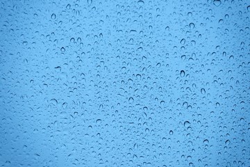 Natural water drops on glass
