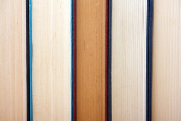 Old hardback books in a row form a background image