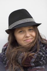 Smiling girl with a black hat