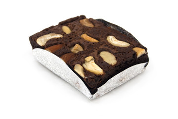 A piece of brownie and cashew isolated on white