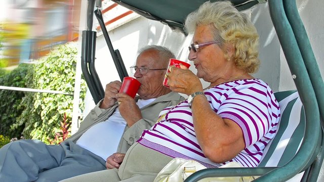 Senior couple sitting together talking and resting