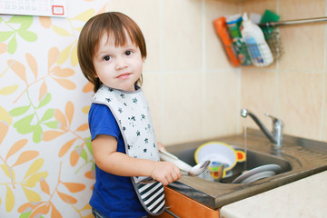 lovely 2 years baby washing dishes