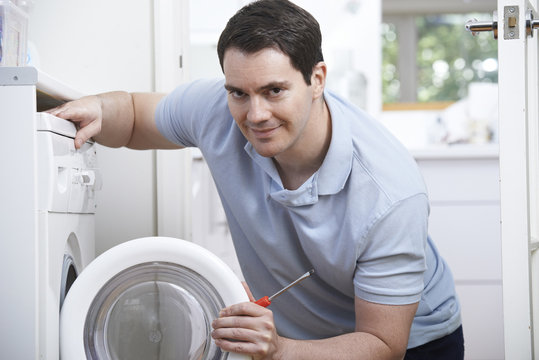 Engineer Mending Domestic Washing Machine