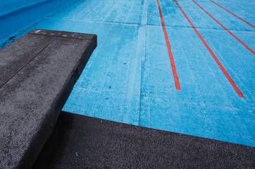 old empty pool with diving board