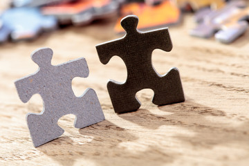 Black and Grey Jigsaw Puzzle Pieces on Table