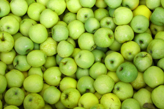 background of green apples on sale at the market
