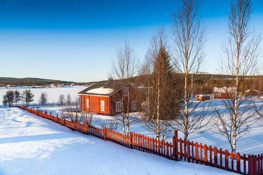 Winter landscape with house at lake in Scandinavia