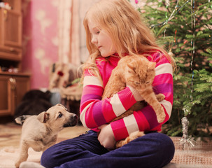 girl with pets on background christmas tree