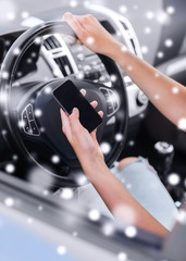 close up of woman with smartphone driving car