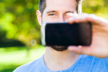 Mann im Park mit Smartphone 3