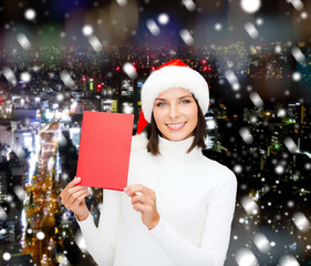 smiling woman in santa hat with greeting card