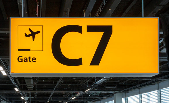 Illuminated sign at airport with gate number