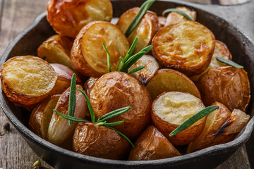 baked potatoes in a pan with rosemary