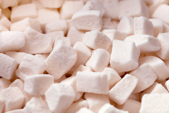 Tender white marshmallow pieces background