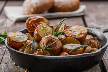 baked potatoes in a pan with rosemary