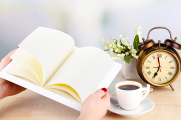 Tablet, cup of coffee and alarm clock, close up