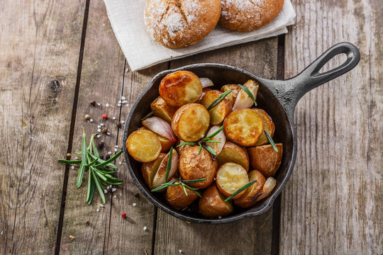 baked potatoes in a pan with rosemary