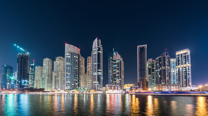 Naklejka na ściany i meble Dubai marina skyscrapers during night hours