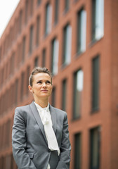 Portrait of business woman in front of office building