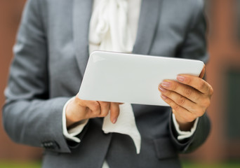 Closeup on business woman using tablet pc