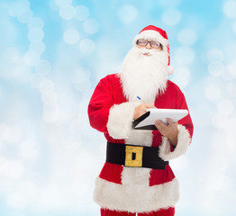 man in costume of santa claus with notepad