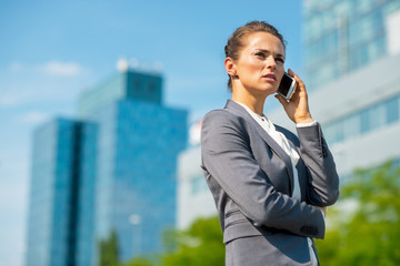 Portrait of happy business woman talking cell phone